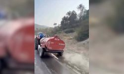 Bursa'da bir çiftçi, patlayan lastiğe rağmen yangına su taşıdı